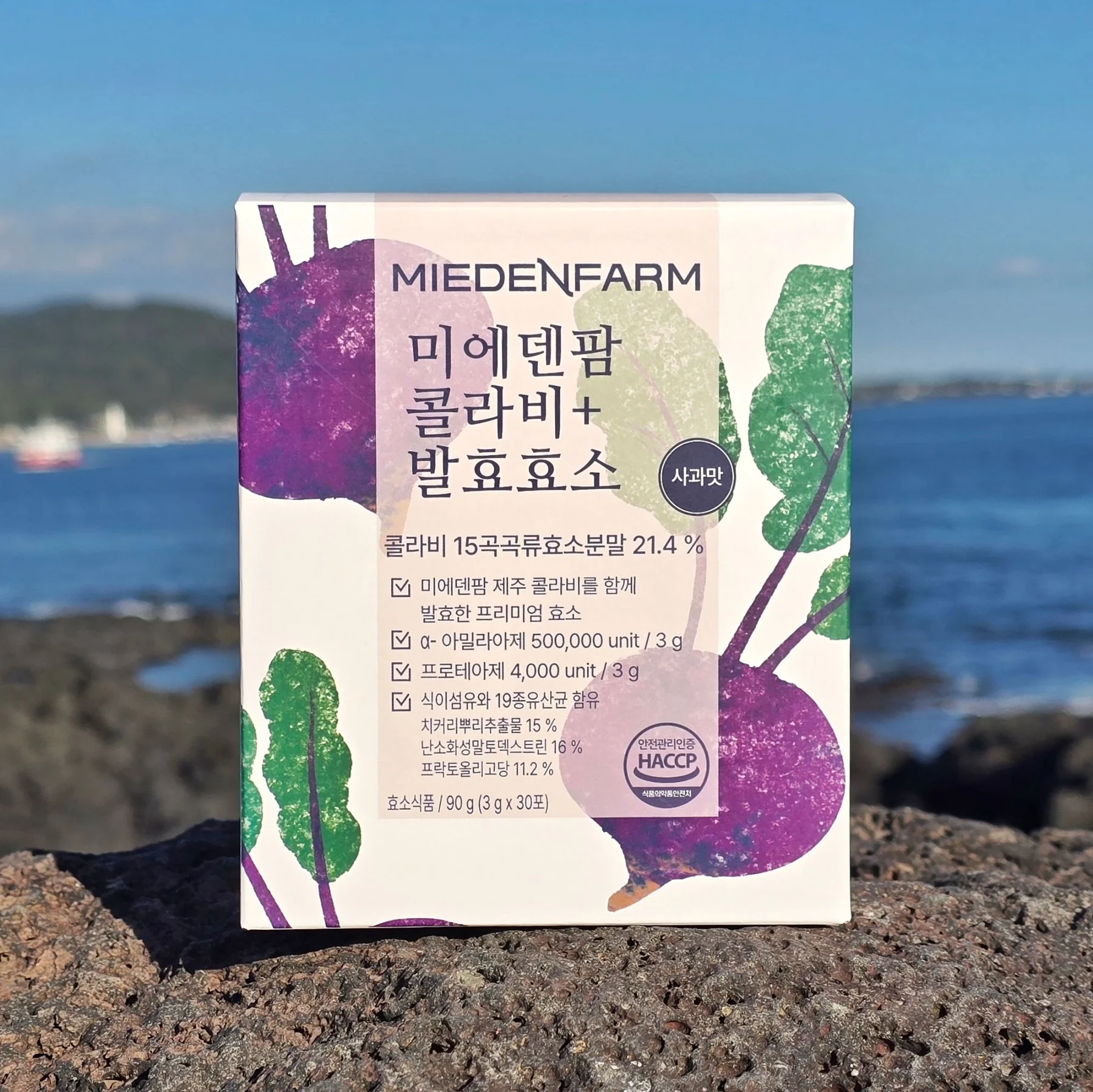 A Kohlrabi+ Fermented Enzyme box on basalt rock by the Jeju sea (photo by MIEDEN FARM)