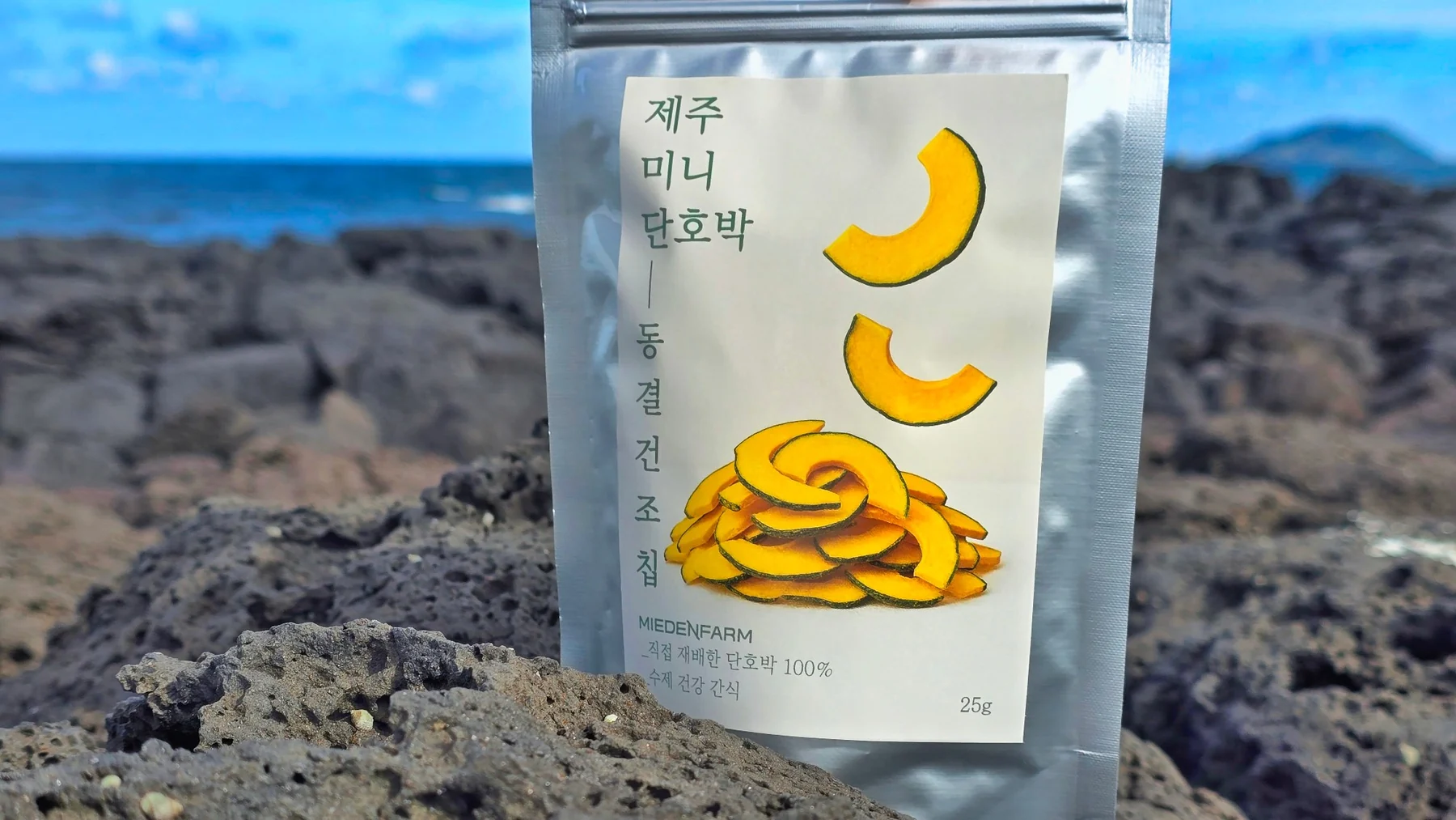 A bag of Jeju mini kabocha freeze-dried chips on basalt rock (photo by MIEDEN FARM)
