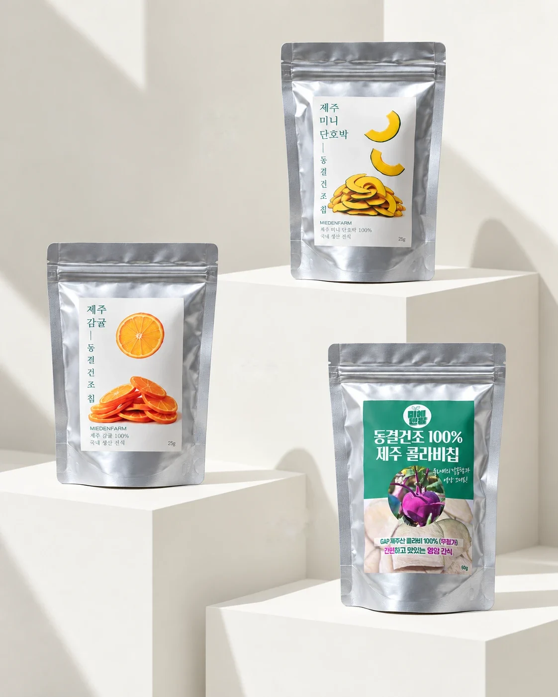 Jeju mini kabocha, tangerine and kohlrabi freeze-dried chip pouches on white stands